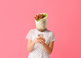 Young woman with tasty burrito instead of her head and mobile phone on pink background