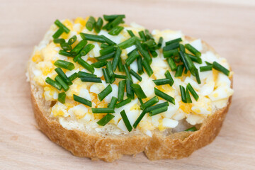 small open sandwich with boiled egg and chives selective focus