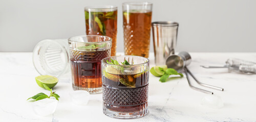 Glasses of tasty Cuba Libre cocktail on table