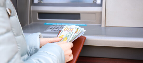 Woman withdrawing money from ATM