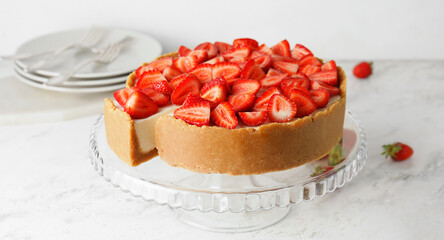 Tasty cheesecake with strawberry on light table