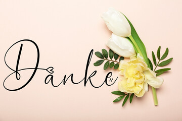 Beautiful flowers and word DANKE (German for Thanks) on pink background