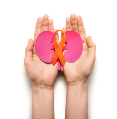 Woman with orange awareness ribbon and paper kidneys on white background