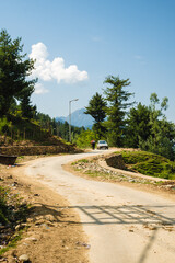 Scenic view on the gravel road with stones and vegetation on roadsides, selective focus. High quality photo.