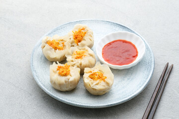 Steamed dumpling dimsum served in plate, close up.