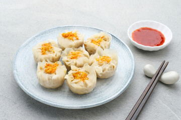 Steamed dumpling dimsum served in plate, close up.