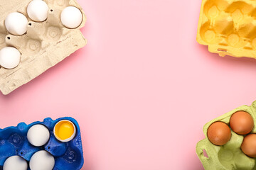 Different holders with chicken eggs on pink background