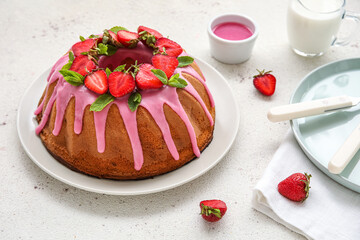 Plate with tasty strawberry cake on light table