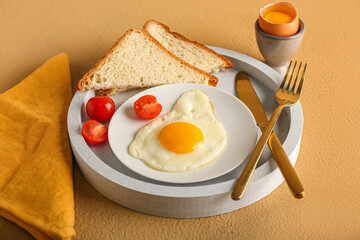 Tray with delicious breakfast on color background
