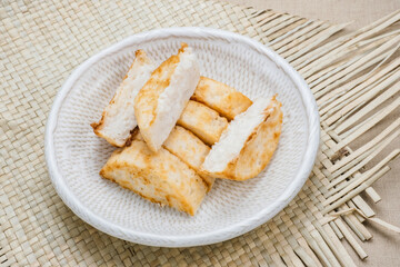 Kue Pancong, Gandos or Bandros is an Indonesian traditional snack made from a mixture of rice flour, grated coconut, and coconut milk.
