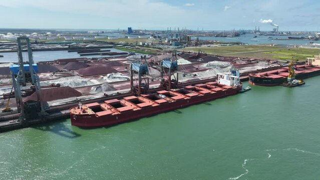 Cranes Unloading a Bulk Carrier Ship at Port