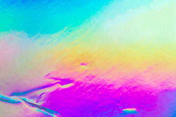 Fototapeta na wymiar Crumpled Holographic rainbow foil iridescent texture abstract hologram background