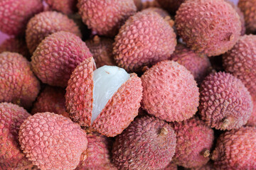 Fresh lychee fruits with one cut open in full frame (manual focus) © Yü Lan