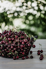Full basket of cherries on a wooden table. selective focus.