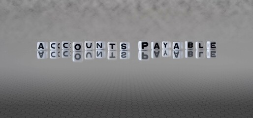 accounts payable word or concept represented by black and white letter cubes on a grey horizon background stretching to infinity