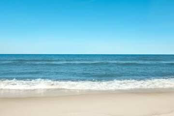 Picturesque view of beautiful sea and sandy beach on sunny day - obrazy, fototapety, plakaty