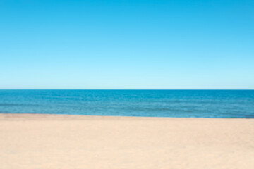 Obraz premium Blurred view of sandy beach near sea