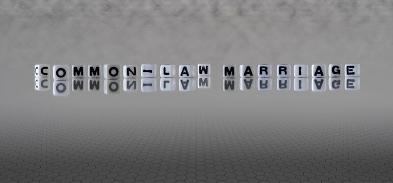 Common Law Marriage Word Or Concept Represented By Black And White Letter Cubes On A Grey Horizon Background Stretching To Infinity