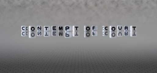contempt of court word or concept represented by black and white letter cubes on a grey horizon...