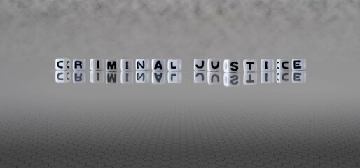 criminal justice word or concept represented by black and white letter cubes on a grey horizon background stretching to infinity