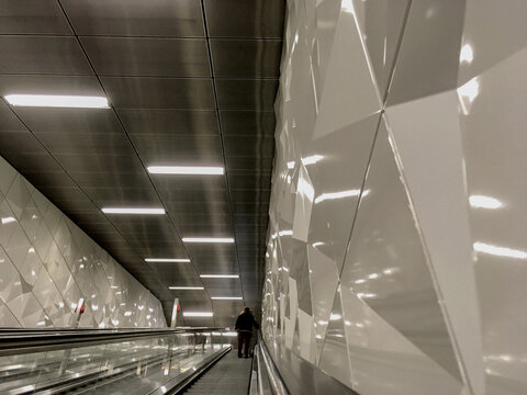 Clean modern interior design architecture inside metro underground subway station in Dusseldorf, Germany for public transport busy rush hour metal surfaces