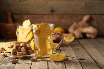 Ginger tea with ingredients on an old wooden table.