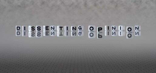 dissenting opinion word or concept represented by black and white letter cubes on a grey horizon...