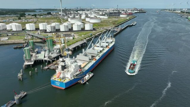 Bulk Carrier Ship at Port Offloading Cargo and Commodities