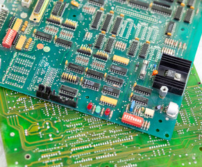Obraz premium Old computer chips that are out of order. Not working microshops with transistors, chips and conductors. Blue system board with microchips and transistors