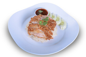 Thai crispy chicken served on steamed rice with sweet chilli sauce and cucumber slices. Traditional south east asian cuisine.and isolate background with clipping path