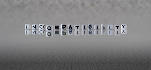 incompatibility word or concept represented by black and white letter cubes on a grey horizon...