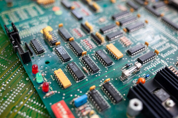 Old computer chips that are out of order. Not working microshops with transistors, chips and conductors. Blue system board with microchips and transistors