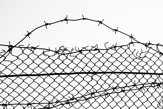 Opening in metallic fence isolated on white background . Challenge. uncertainty. breakthrough concept. metaphor. Chain-link, wire netting, wire-mesh, cyclone hurricane fence.