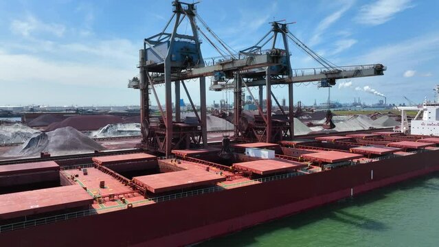 Bulk Carrier Ship Offloading Cargo By Crane for Processing