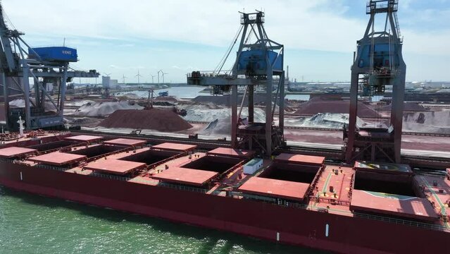 Bulk Carrier Ship Offloading Cargo By Crane for Processing