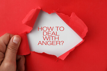 Woman tearing red paper to reveal inscription How To Deal With Anger? on white background, top view - Powered by Adobe
