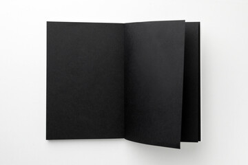 Blank black sketchbook on white background, top view