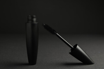Black mascara with wand on dark background