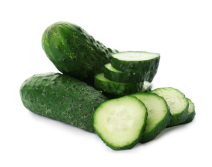 Whole and cut cucumbers on white background