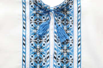 Beautiful white shirt with light blue Ukrainian national embroidery, top view