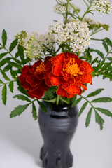 a bouquet of flowers in a black vase
