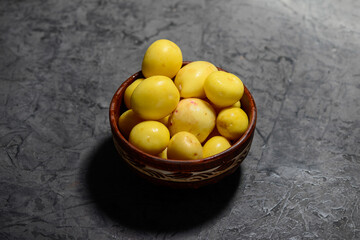 fresh peeled young potatoes in a clay plate
