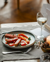 Gourmet restaurant dish with tuna and wine on the table