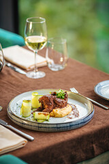 Gourmet restaurant quail dish with puree and red wine