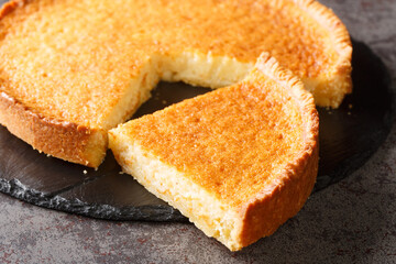 Homemade delicious dessert buttermilk pie in a slate plate on the table. Horizontal