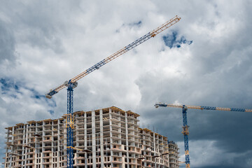 Lifting tower crane at housing construction.