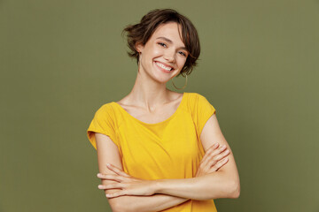 Young confident satisfied smiling fun cool happy woman she 20s wear yellow t-shirt hold hands...