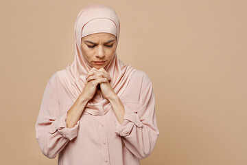 Young arabian asian muslim woman she wear abaya hijab pink clothes hold hands folded in prayer...