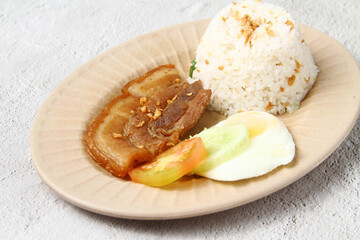Freshly cooked Filipino food called Pork Chop Silog or pork chop, egg and fried rice