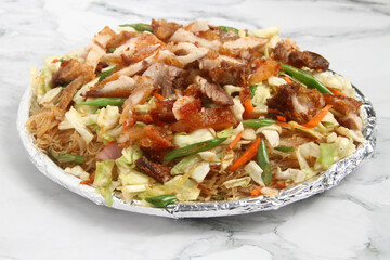 Freshly cooked Filipino food called Pancit Bihon with Lechon